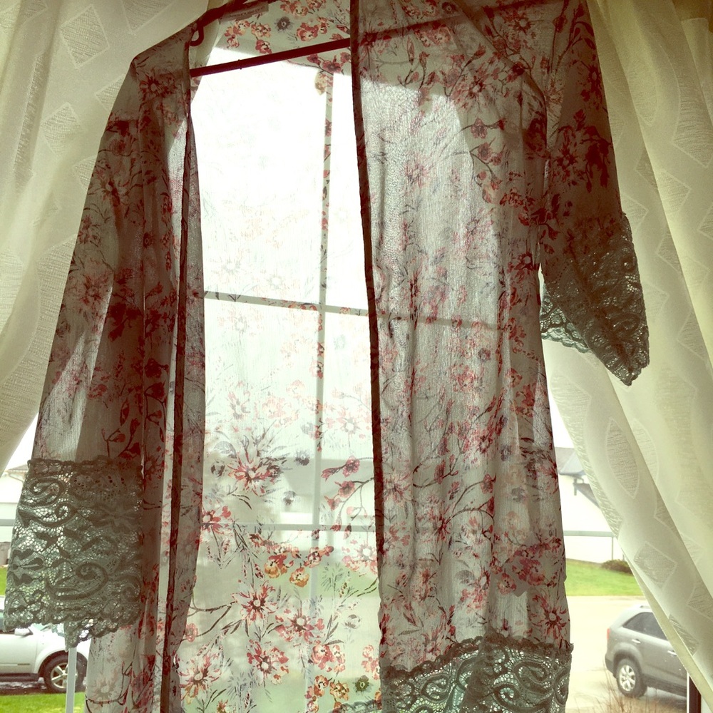 Blue cardigan with pink flower detailing.